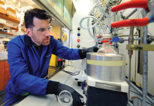 Dr. Leibfarth in the lab, using equipment.