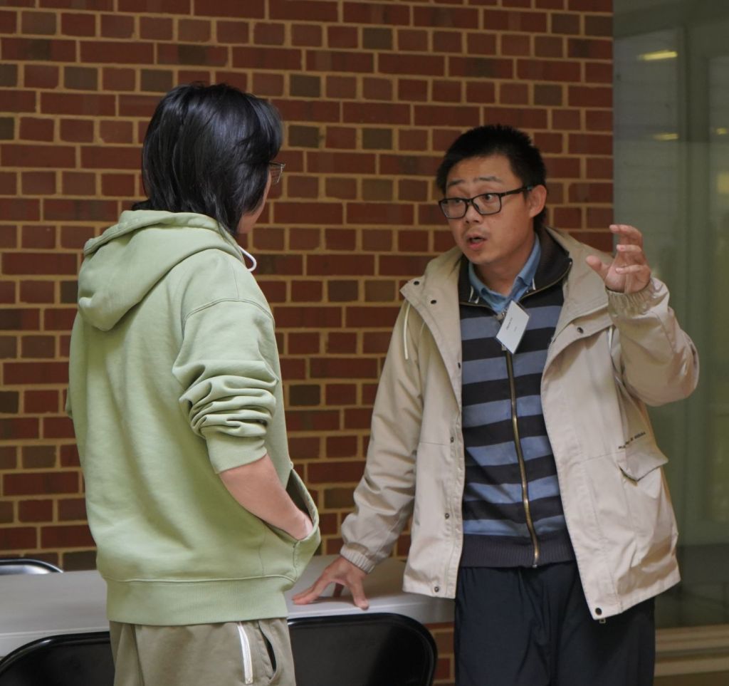 Professor Lu explains his research to an undergraduate student.