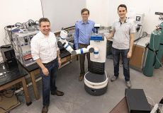 Left to right, Dr. Jim Cahoon, chair of the Department of Chemistry; Dr. Ron Alterovitz, Lawrence Grossberg Distinguished Professor in the Department of Computer Science; and Angelos Angelopoulos, a fourth-year graduate student in Dr. Alterovitz’s lab, stand beside their AI-driven mobile robot for automating chemistry lab tasks. (Johnny Andrews/UNC-Chapel Hill)